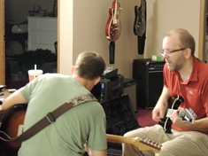 Action shot.  That&#39;s me in the business casual and my good buddy Neil laying down some Strat mojo.