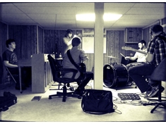 The band hard at work. That day I was using my minimal setup. Kick, floor tom, snare, high hat, and crash/ride. (Photo taken by Holly M.)